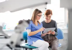 a dentist talking to woman in dentist surgery a d 2021 08 27 17 58 18 utc 1